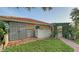 Exterior shot showcasing a home with a red tile roof, green pergola, brick pavers, and ample yard space at 387 Eden Dr Dr, Englewood, FL 34223
