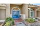 Inviting front entry featuring a bright blue double door, red brick pavers, and lush landscaping at 387 Eden Dr Dr, Englewood, FL 34223