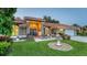 Beautiful home featuring a meticulously landscaped front yard with a decorative fountain and vibrant green grass at 387 Eden Dr Dr, Englewood, FL 34223
