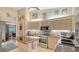 Charming kitchen features modern stainless steel appliances, tile backsplash, and cooktop island at 387 Eden Dr Dr, Englewood, FL 34223