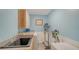 Functional laundry room with ample storage, a sink, and modern appliances at 387 Eden Dr Dr, Englewood, FL 34223