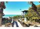 A lifeguard stand overlooks the picturesque beach and blue ocean, framed by swaying palm trees at 387 Eden Dr Dr, Englewood, FL 34223