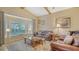 Living room with bay window, comfortable seating, natural light, and vaulted ceilings at 387 Eden Dr Dr, Englewood, FL 34223