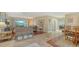 Open-concept living room with tile flooring, comfortable seating, and access to the outdoor patio at 387 Eden Dr Dr, Englewood, FL 34223