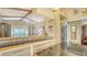 Spacious living room area with large window and bar top looking into the kitchen at 387 Eden Dr Dr, Englewood, FL 34223