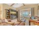 Open living room with comfortable furniture, large bay window, and vaulted ceilings at 387 Eden Dr Dr, Englewood, FL 34223