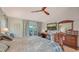 Spacious main bedroom features a ceiling fan, television, and a sliding glass door at 387 Eden Dr Dr, Englewood, FL 34223