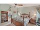 This main bedroom showcases a four-poster bed, an open bookshelf and an access to a walk-in closet at 387 Eden Dr Dr, Englewood, FL 34223