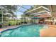 Sparkling pool with screen enclosure offers views of the well-manicured lawn and serene surroundings at 387 Eden Dr Dr, Englewood, FL 34223