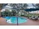 Sparkling screened-in pool area with lounge chairs and serene backyard views at 387 Eden Dr Dr, Englewood, FL 34223