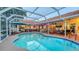 A sparkling pool is surrounded by outdoor living spaces and offers views of the landscaped backyard at 387 Eden Dr Dr, Englewood, FL 34223