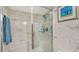 Modern shower features marble tile and a glass door, providing a luxurious spa-like experience at 387 Eden Dr Dr, Englewood, FL 34223