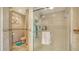 Tiled shower with frameless glass door and a built in niche at 387 Eden Dr Dr, Englewood, FL 34223