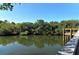 Community water view with lush foliage in an ideal natural surrounding and private pier access, perfect for relaxing at 387 Eden Dr Dr, Englewood, FL 34223