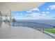 A wide-open balcony with glass railings overlooks the water and an expansive landscape at 4035 Bay Shore Rd, Sarasota, FL 34234