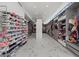 Long walk-in closet with racks and shelves of clothes and shoes and beautiful marble floors at 4035 Bay Shore Rd, Sarasota, FL 34234