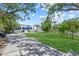 Modern home with a large front yard and patterned driveway for parking at 4035 Bay Shore Rd, Sarasota, FL 34234