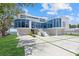 Beautiful modern home featuring a sleek design, a large driveway, and a well-manicured front lawn at 4035 Bay Shore Rd, Sarasota, FL 34234