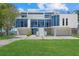 Modern waterfront home with sleek white exterior, glass windows, and an expansive driveway with manicured lawn at 4035 Bay Shore Rd, Sarasota, FL 34234