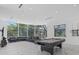 Bright game room with a pool table, comfortable seating, and natural light streaming through large windows at 4035 Bay Shore Rd, Sarasota, FL 34234