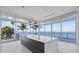 Modern kitchen with large island, floor-to-ceiling windows, and stunning waterfront view at 4035 Bay Shore Rd, Sarasota, FL 34234