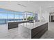 Modern kitchen with sleek white countertops, gray cabinetry, and stunning water view windows at 4035 Bay Shore Rd, Sarasota, FL 34234
