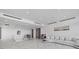 Bright, modern living room with sleek, white marble floors and contemporary furnishings at 4035 Bay Shore Rd, Sarasota, FL 34234