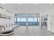 Expansive living room featuring floor to ceiling windows with amazing ocean views and marble flooring at 4035 Bay Shore Rd, Sarasota, FL 34234