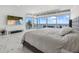 Spacious bedroom with ocean views through walls of windows, a TV, and marble floors at 4035 Bay Shore Rd, Sarasota, FL 34234