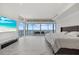 Spacious bedroom with ocean views, a TV, marble floors, and outdoor access at 4035 Bay Shore Rd, Sarasota, FL 34234