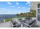 Relaxing patio with comfortable seating and views of the water and the community pool at 4035 Bay Shore Rd, Sarasota, FL 34234