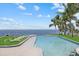 A lavish outdoor pool offers a bar with stools and chairs on the adjacent green space at 4035 Bay Shore Rd, Sarasota, FL 34234