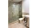 Bathroom featuring tiled shower with glass door, pedestal sink, and matching toilet at 4037 Crockers Lake Blvd # 24, Sarasota, FL 34238