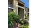 Inviting condominium exterior featuring a landscaped entrance, balconies, and a well-maintained facade at 4037 Crockers Lake Blvd # 24, Sarasota, FL 34238