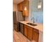 Well-lit kitchen featuring stainless steel appliances, modern countertops, and wood cabinets at 4037 Crockers Lake Blvd # 24, Sarasota, FL 34238