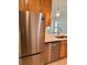 Kitchen featuring stainless steel appliances, stone countertops, and wood cabinets at 4037 Crockers Lake Blvd # 24, Sarasota, FL 34238