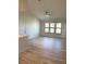 Bright living room featuring wood-look flooring, a ceiling fan, and large windows at 4037 Crockers Lake Blvd # 24, Sarasota, FL 34238