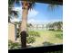 Scenic view from the balcony of a lush lawn and a serene lake, enhancing the condo's appeal at 4037 Crockers Lake Blvd # 24, Sarasota, FL 34238
