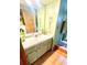 Bathroom features a modern vanity with integrated sink, a matching mirror, and wood-look flooring at 4042 S Lockwood Ridge Rd, Sarasota, FL 34231