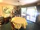 Dining room showcases a round table near sliding doors to an outdoor covered patio at 4042 S Lockwood Ridge Rd, Sarasota, FL 34231