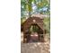 Inviting entrance to the home with a covered arbor, decorative lattice and brick pathway at 4042 S Lockwood Ridge Rd, Sarasota, FL 34231