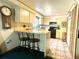 Eat-in kitchen with breakfast bar and adjacent appliances; features decorative tile flooring at 4042 S Lockwood Ridge Rd, Sarasota, FL 34231