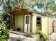 Exterior view of a shed with a covered porch, offering a functional outdoor space at 4042 S Lockwood Ridge Rd, Sarasota, FL 34231