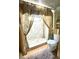 Modern shower area with decorative curtain, beige flooring, and adjacent toilet at 4042 S Lockwood Ridge Rd, Sarasota, FL 34231
