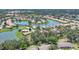 High aerial view showcases residences nestled around a scenic lake in the community at 4121 Reflections Pkwy, Sarasota, FL 34233
