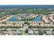 High aerial of residences built around a lake, with mature trees and roads throughout at 4121 Reflections Pkwy, Sarasota, FL 34233