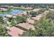 Aerial view of neighborhood homes surrounding a lake with mature trees and lush landscaping at 4121 Reflections Pkwy, Sarasota, FL 34233