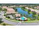 Aerial view of community pool and spa, plus neighborhood homes near a lake at 4121 Reflections Pkwy, Sarasota, FL 34233