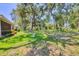 Expansive backyard featuring lush green grass, mature trees and landscaping at 4121 Reflections Pkwy, Sarasota, FL 34233