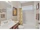 Bright bathroom featuring vanity with wood cabinets, and a shower/tub combo at 4121 Reflections Pkwy, Sarasota, FL 34233
